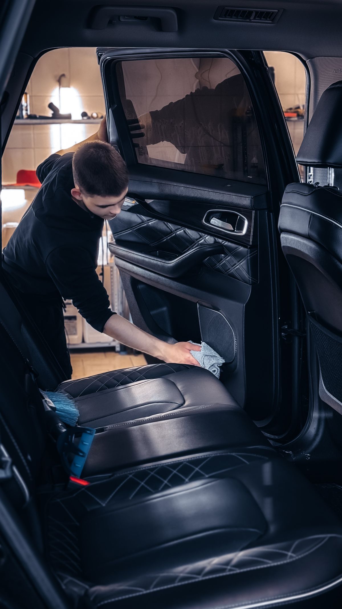 Car seats and interior surfaces being cleaned by hand